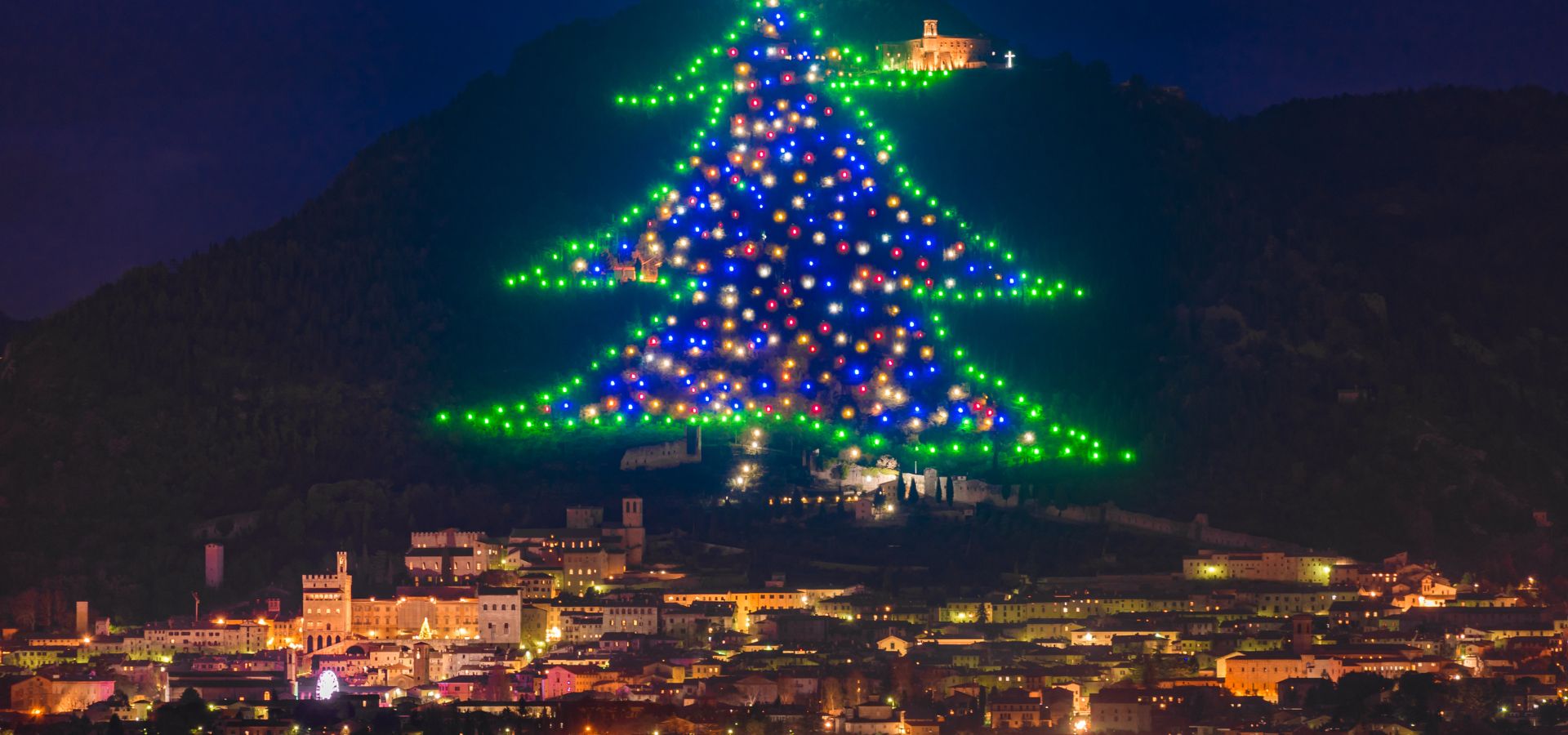 Gubbio illuminated with the giant Christmas tree on Mount Ingino