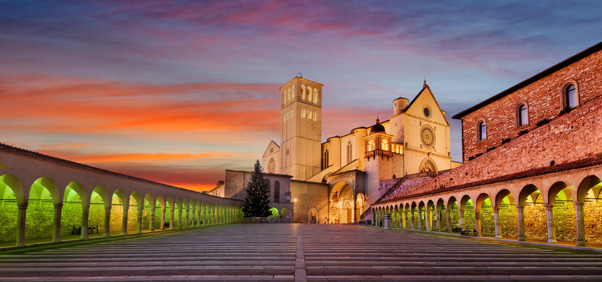 Basilica of Saint Francis in Assisi illuminated at sunset