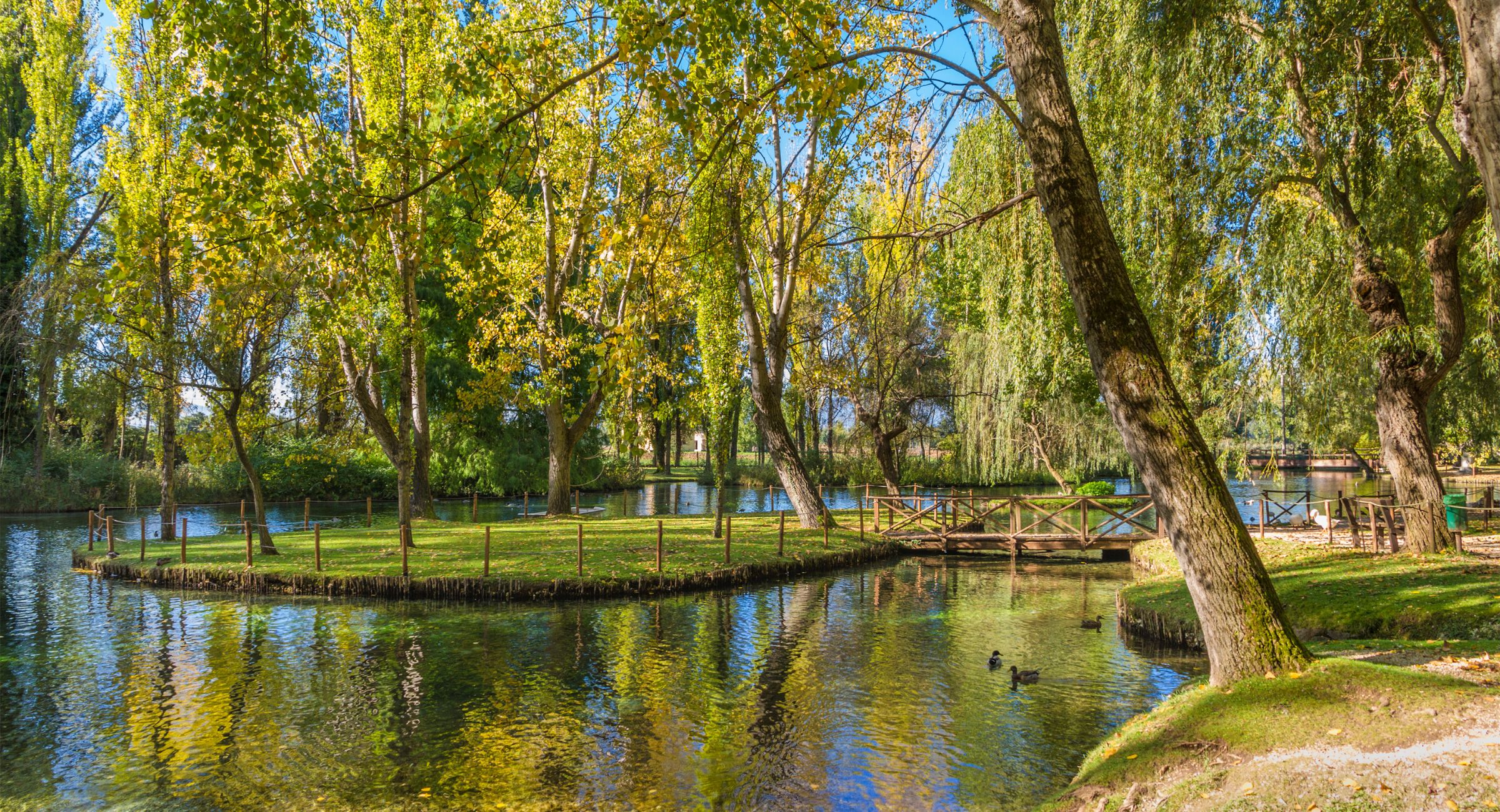 Crystal-clear waterways and centuries-old trees at the Fonti del Clitunno in Umbria
